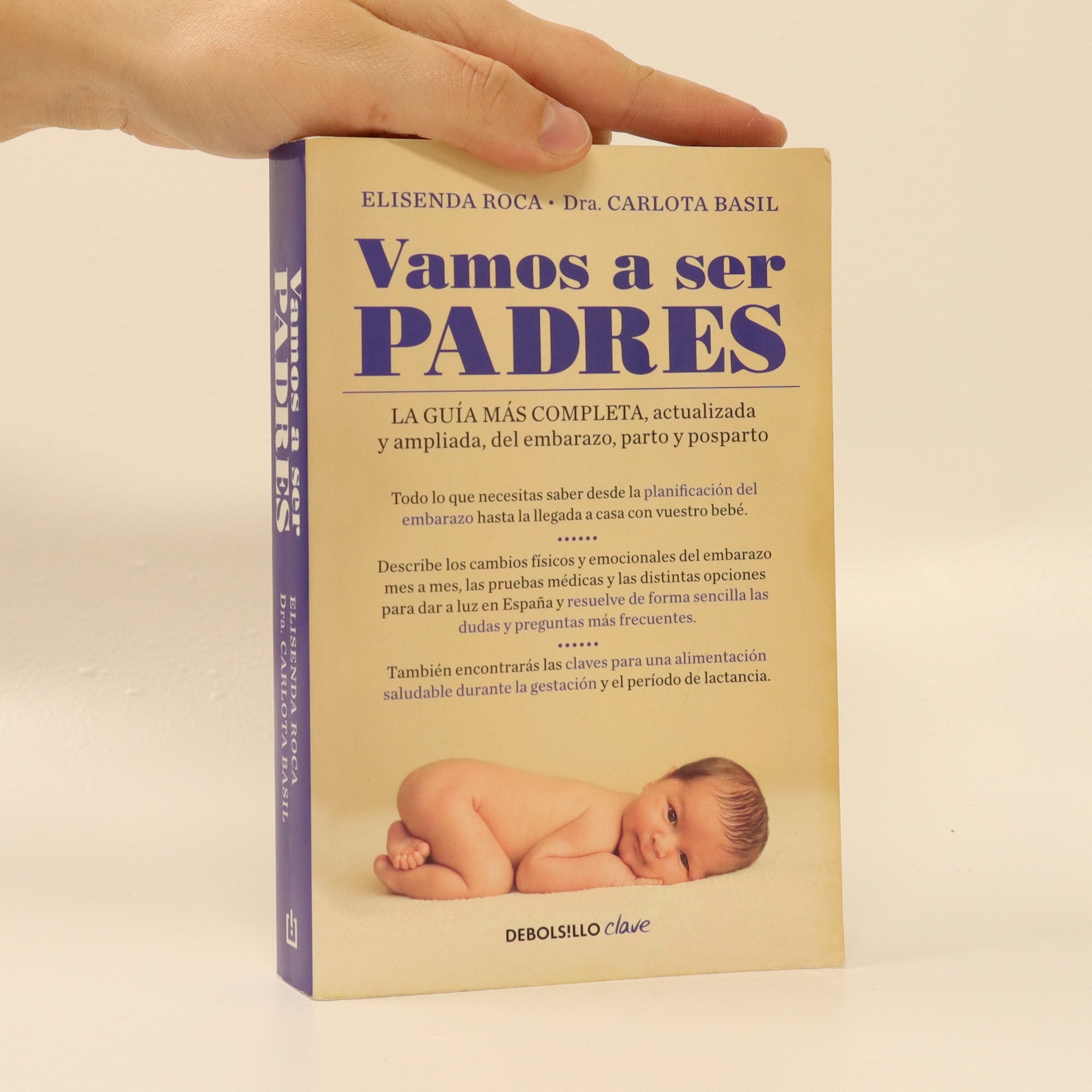 Portada del libro "Vamos a ser padres" de Elisenda Roca y Dra. Carlota Basil, guía completa del embarazo, parto y posparto con imagen de bebé recién nacido en posición fetal sobre fondo beige, editorial DeBolsillo Clave