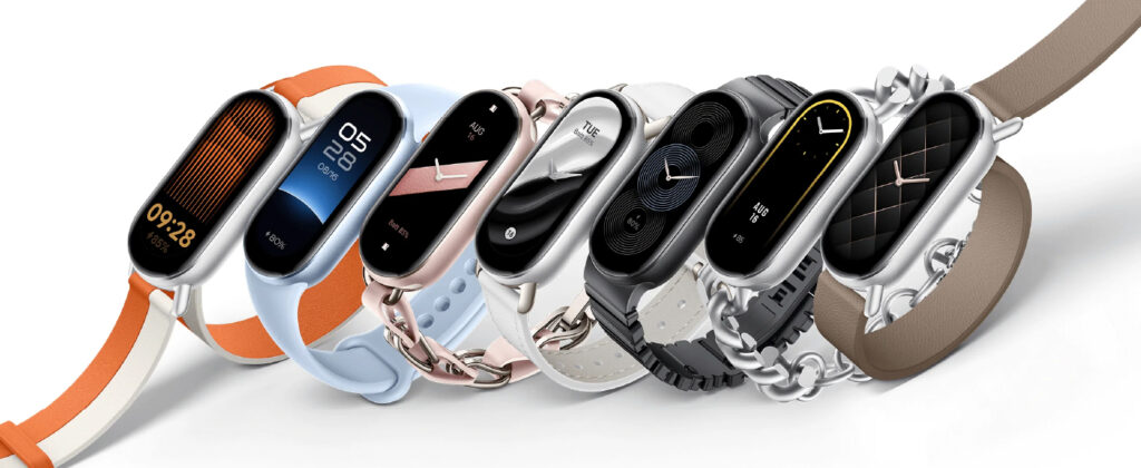 Colección de Xiaomi Smart Band 9 mostrando siete modelos con correas en naranja, azul, rosa, blanco, negro y marrón, exhibiendo diferentes esferas digitales y diseños minimalistas